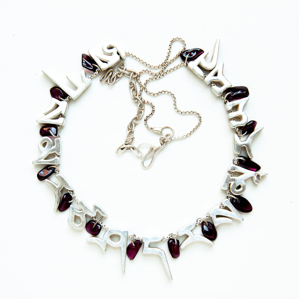 mantra necklace with 13 rock tumbled purple garnets, silver letters and chain