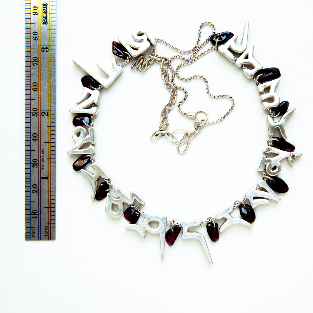 mantra necklace with 13 rock tumbled purple garnets, silver letters and chain-measure