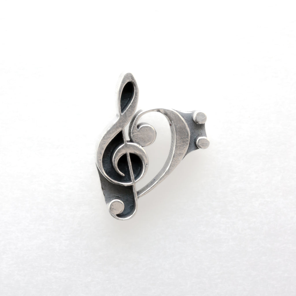 a combination of the treble and bass clefs single silver earring