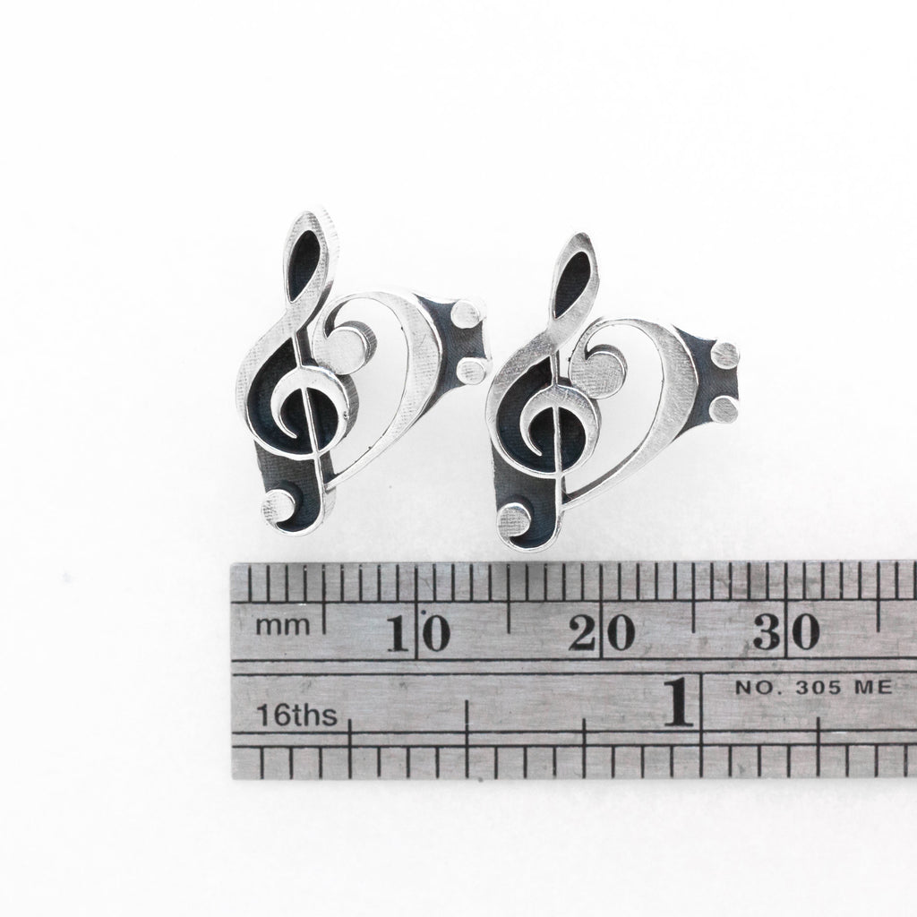 a combination of the treble and bass clefs silver earrings measure