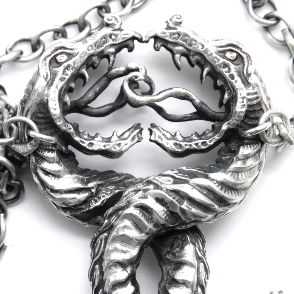 Twisting Love Snakes silver pendant with hidden hearts-head detail
